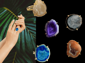 Hand wearing a blue druzy gemstone ring with palm leaves in the background.